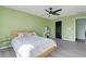 Green bedroom with gray wood-look floors and a modern ceiling fan at 2120 Windsor Lake Cir, Sanford, FL 32773