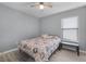 Cozy bedroom features a ceiling fan and light gray wood-look floors at 2120 Windsor Lake Cir, Sanford, FL 32773