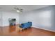 Bright living room features wood floors, ceiling fan, and modern blue sofa at 2120 Windsor Lake Cir, Sanford, FL 32773