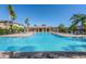 Community pool featuring ample seating and a covered area for relaxation and socializing at 2120 Windsor Lake Cir, Sanford, FL 32773