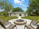Backyard with firepit, chairs, and exterior view of house at 2193 County Road 204, Oxford, FL 34484