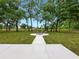 Serene backyard featuring a fire pit, seating, and lush greenery at 2193 County Road 204, Oxford, FL 34484