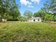 Expansive backyard featuring lush greenery and a cozy outdoor seating area, perfect for relaxation and entertaining at 2193 County Road 204, Oxford, FL 34484