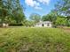 Expansive backyard featuring a well-maintained lawn and a charming outdoor seating area at 2193 County Road 204, Oxford, FL 34484