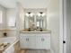 Dual sink bathroom vanity with white cabinetry and modern fixtures at 2193 County Road 204, Oxford, FL 34484