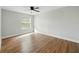 Light-filled bedroom with wood-look floors and a large window at 2193 County Road 204, Oxford, FL 34484