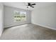 Bright bedroom with neutral carpet, a large window, and ample natural light at 2193 County Road 204, Oxford, FL 34484
