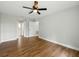 Bedroom featuring wood-look floors, a ceiling fan, and access to multiple doorways at 2193 County Road 204, Oxford, FL 34484