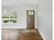 Inviting entryway featuring a stylish front door, wood flooring, and a sunlit window at 2193 County Road 204, Oxford, FL 34484