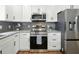 Well-equipped kitchen with stainless steel appliances, granite countertops, and white cabinets at 2193 County Road 204, Oxford, FL 34484