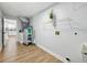 Functional laundry room area with open shelving, utility sink, and a peek into the kitchen at 2193 County Road 204, Oxford, FL 34484