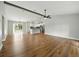Bright, open-concept living room with wood floors and seamless flow into the modern kitchen at 2193 County Road 204, Oxford, FL 34484
