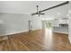 Open-concept living area with modern fixtures, wood floors, and a seamless flow to the kitchen at 2193 County Road 204, Oxford, FL 34484