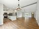 Spacious living area with wood floors, modern lighting, and a kitchen island for entertaining at 2193 County Road 204, Oxford, FL 34484