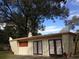 Exterior view of meditation center featuring double doors, red signage, and peaked facade at 2223 Kilmer Ln, Apopka, FL 32703