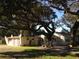 Exterior view of property with mature trees, lawn, and meditation center at 2223 Kilmer Ln, Apopka, FL 32703