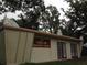 Exterior of meditation center featuring double doors, red signage, and peaked facade at 2223 Kilmer Ln, Apopka, FL 32703