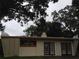 Exterior of meditation center featuring double doors, red signage, and peaked facade at 2223 Kilmer Ln, Apopka, FL 32703