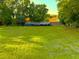 Large grassy area with trees and other buildings nearby offers space for construction or outdoor activities at 2223 Kilmer Ln, Apopka, FL 32703