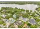 Aerial view of a property featuring mature trees, swimming pool, and lake access at 2500 Lake Shore Dr, Orlando, FL 32803