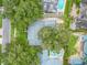 Aerial view showcasing the home's roof, mature trees, and in-ground swimming pool at 2500 Lake Shore Dr, Orlando, FL 32803