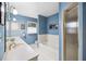 Bathroom with blue walls, white fixtures, and shower-tub combo at 2500 Lake Shore Dr, Orlando, FL 32803