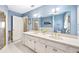 Light and bright bathroom with double sink vanity, white cabinets and brass hardware at 2500 Lake Shore Dr, Orlando, FL 32803