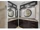 Modern bathroom with dual sinks, round mirrors, and dark wood cabinets at 2500 Lake Shore Dr, Orlando, FL 32803