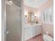 Charming bathroom with a vanity, classic fixtures, and a shower enclosed by a textured glass door at 2500 Lake Shore Dr, Orlando, FL 32803