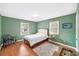 Bright bedroom with a classic bed, ample natural light, and traditional wood flooring at 2500 Lake Shore Dr, Orlando, FL 32803