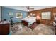 Bedroom featuring wood-paneled walls, natural light, and area rugs at 2500 Lake Shore Dr, Orlando, FL 32803