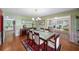 Elegant dining room featuring a glass top table, a decorative rug, and refined architectural trim at 2500 Lake Shore Dr, Orlando, FL 32803