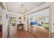 Foyer with brick flooring, decorative lighting, and views into living and dining areas at 2500 Lake Shore Dr, Orlando, FL 32803