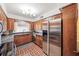 Cozy kitchen with stainless steel fridge, wood cabinets and tiled flooring at 2500 Lake Shore Dr, Orlando, FL 32803