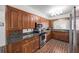 Kitchen with wood cabinets, stone countertops, and stainless steel appliances at 2500 Lake Shore Dr, Orlando, FL 32803