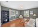 Cozy living room with natural light, hardwood floors, neutral furniture, and bookcase at 2500 Lake Shore Dr, Orlando, FL 32803
