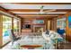 Inviting living room features a brick fireplace, ceiling fan, and sliding glass doors to the yard at 2500 Lake Shore Dr, Orlando, FL 32803