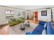 Stylish living room with hardwood floors, colorful seating, and large windows with natural light at 2500 Lake Shore Dr, Orlando, FL 32803