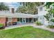 Brick patio with seating, grill, and views of the lush green lawn at 2500 Lake Shore Dr, Orlando, FL 32803