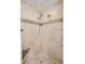 Shower stall with stone-look tiling, shower head, and built-in seat at 2500 Lake Shore Dr, Orlando, FL 32803