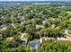 Property aerial view with a yard, screened pool, and surrounding trees at 2608 Westminster Ter, Oviedo, FL 32765