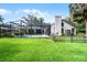 Manicured lawn and fenced yard leading to the screened pool at 2608 Westminster Ter, Oviedo, FL 32765