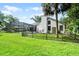 View of the house featuring a large, grassy yard and screened pool area at 2608 Westminster Ter, Oviedo, FL 32765