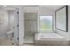 Bright bathroom featuring a walk-in shower, soaking tub under a window, and a separate toilet room at 2608 Westminster Ter, Oviedo, FL 32765