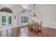 Elegant dining room with hardwood floors, large windows, and a stylish chandelier at 2608 Westminster Ter, Oviedo, FL 32765