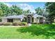 Charming home with lush green lawn, manicured bushes, and an inviting front entrance at 2608 Westminster Ter, Oviedo, FL 32765