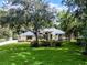 Exterior shot of a home featuring mature shade trees and a green lawn at 2608 Westminster Ter, Oviedo, FL 32765