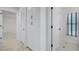 Hallway featuring ample storage space with white cabinets and views to rooms with large windows at 2608 Westminster Ter, Oviedo, FL 32765