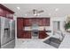 This is a beautiful kitchen with stainless steel appliances and dark wood cabinets at 2608 Westminster Ter, Oviedo, FL 32765