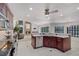 Open kitchen view with granite countertops and stainless steel appliances, next to a fireplace at 2608 Westminster Ter, Oviedo, FL 32765
